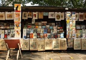 A stand of a bouquiniste (french term for second-hand books resellers) , in Paris, near the Cathedral Notre-Dame of Paris. Bouquinistes can be considered a landmark of Paris. There are nearly 250 of them, mainly located in the central area of the city, alongside the banks of the Seine river.
