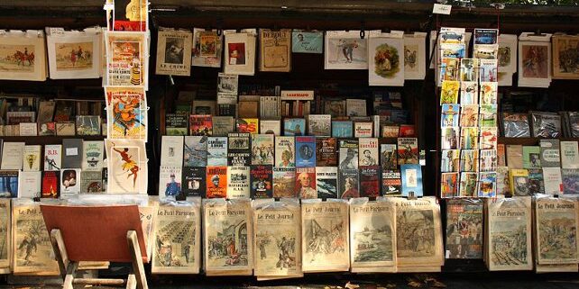A stand of a bouquiniste (french term for second-hand books resellers) , in Paris, near the Cathedral Notre-Dame of Paris. Bouquinistes can be considered a landmark of Paris. There are nearly 250 of them, mainly located in the central area of the city, alongside the banks of the Seine river.