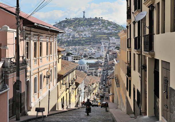 Quito, capital of Ecuador, Garcia Moreno street in the historic center of the city. The Virgin of Quito is seen in the background.
